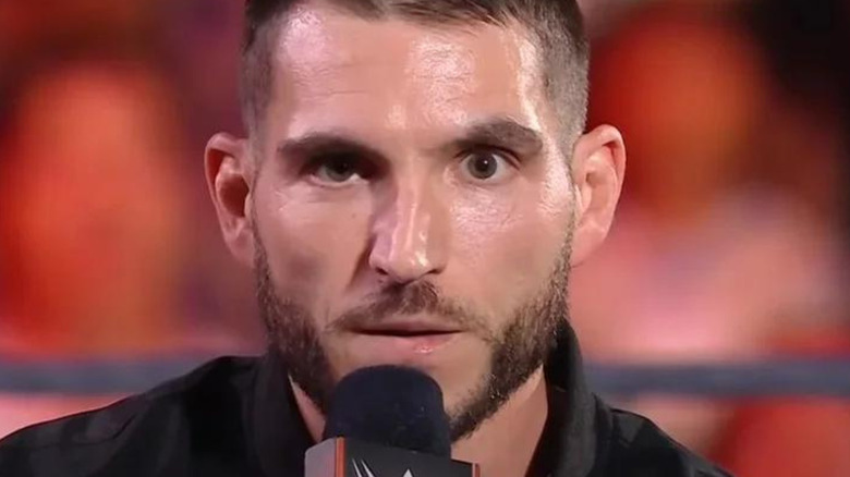 Johnny Gargano holding microphone