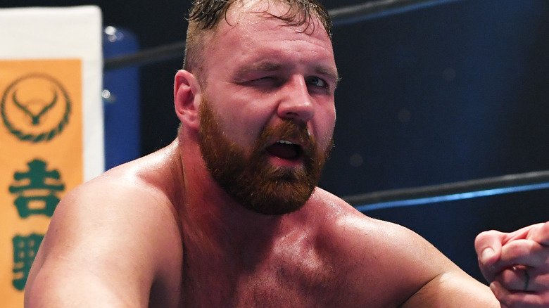 Jon Moxley with one eye closed during a match in NJPW