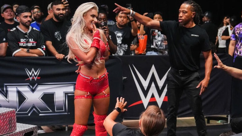 Blake Monroe stands over a fallen Jordynne Grace at ringside on an episode of 