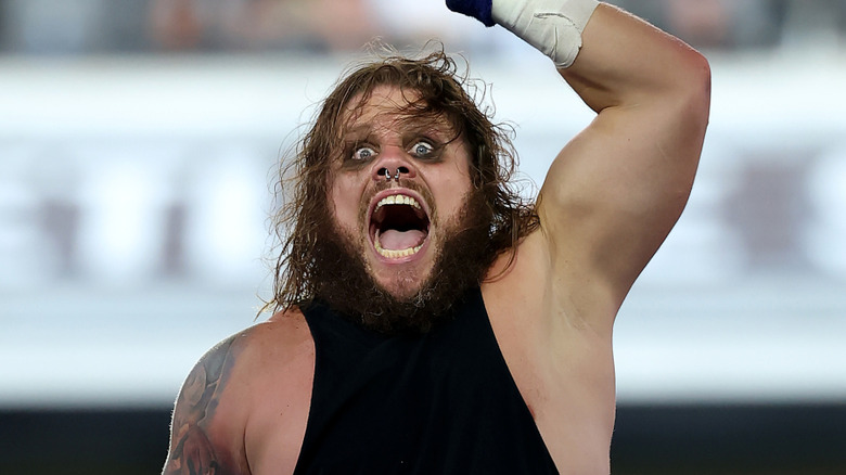 Former WWE Tag Team Champion Joe Gacy celebrates climbing the ladder and retrieving his tag team title at SummerSlam 2025
