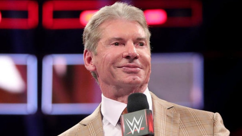 Vince McMahon holds mic
