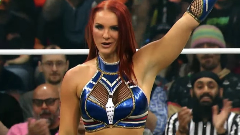 Kamille smirks as she raises her arm post-victory