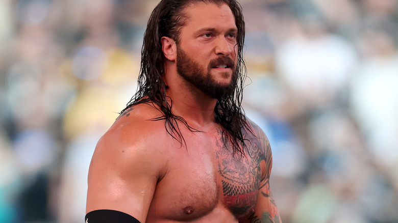 Karrion Kross stands shirtless during his entrance.