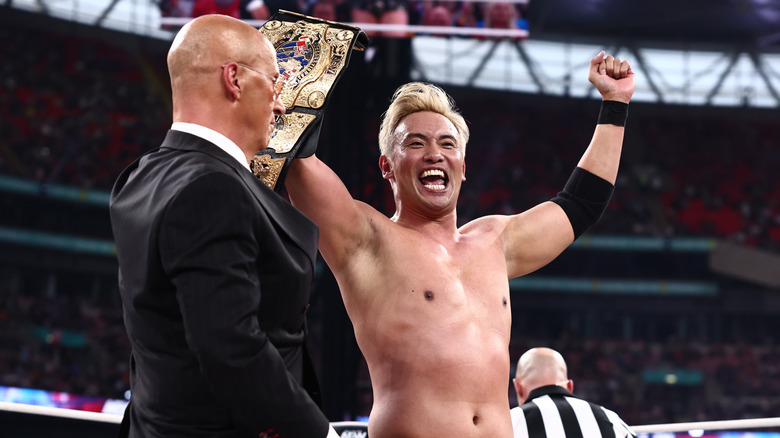 Kazuchika Okada holds up the AEW International Championship alongside Don Callis after his victory at AEW All In London 2026.