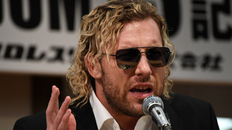Kenny Omega on a microphone