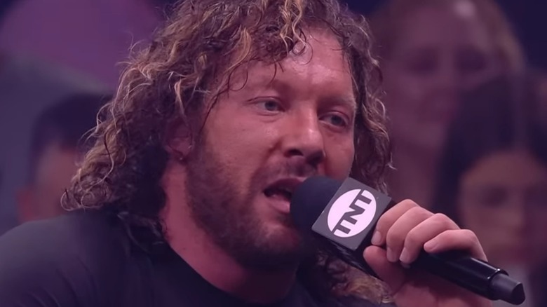 Kenny Omega speaks into mic