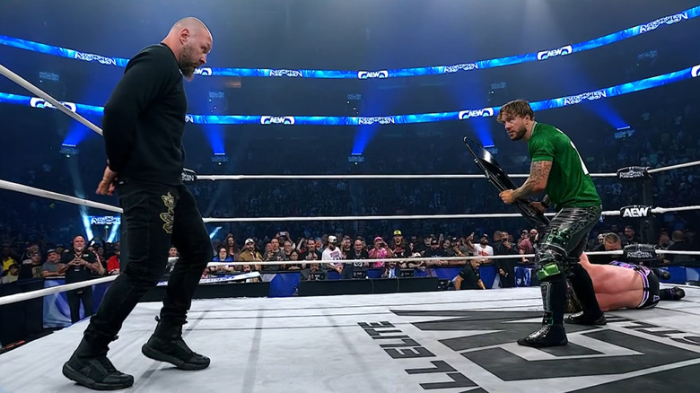 Will Ospreay wards off Jon Moxley with a steel chair