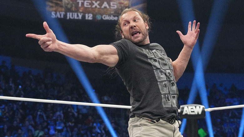 Kenny Omega looks to set up the V Trigger in the middle of the ring during a segment on 