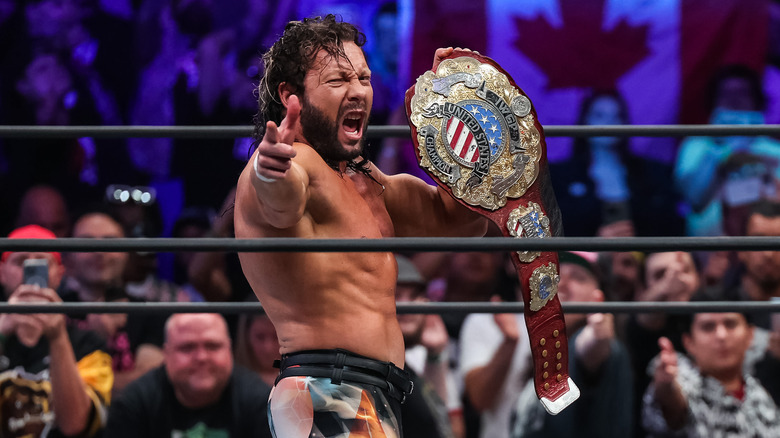 Kenny Omega poses with title