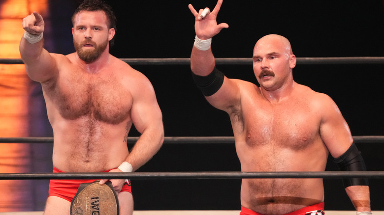 Cash Wheeler and Dax Harwood pointing to fans