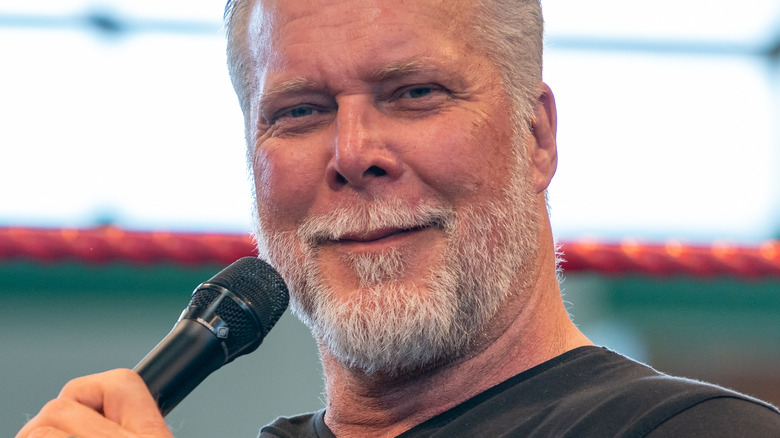 Kevin Nash holds mic