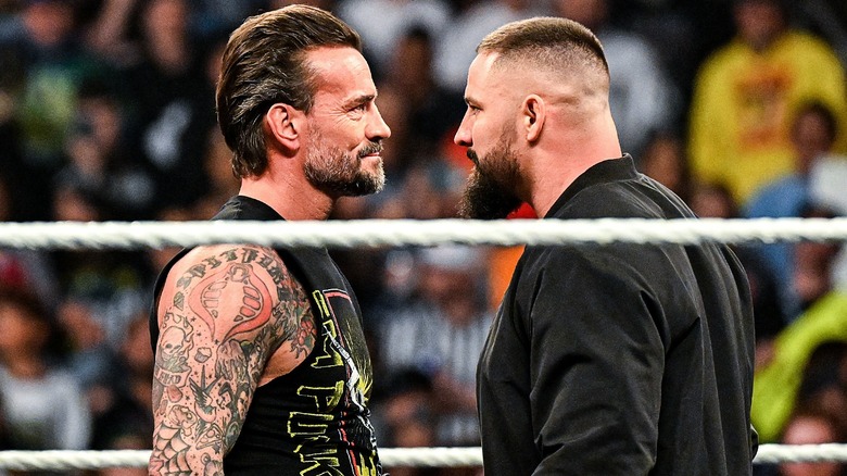 CM Punk and Bron Breakker staring one another down during an episode of 
