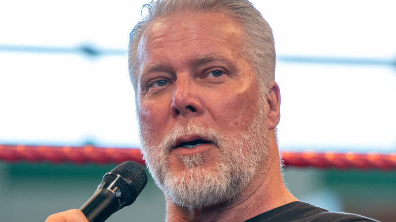 Close-up of Kevin Nash holding a mic
