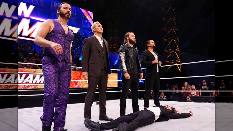 The Elite (Nicholas Jackson, Kazuchika Okada, Jack Perry, and Matthew Jackson) stand over Tony Khan