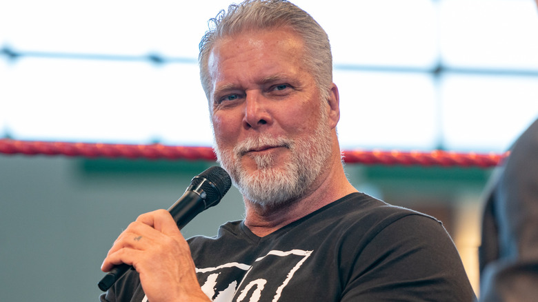 Kevin Nash holding a microphone