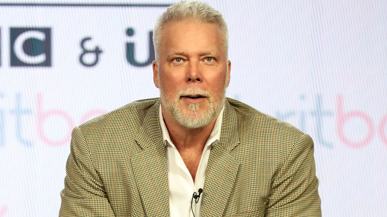 Kevin Nash in a beige suit
