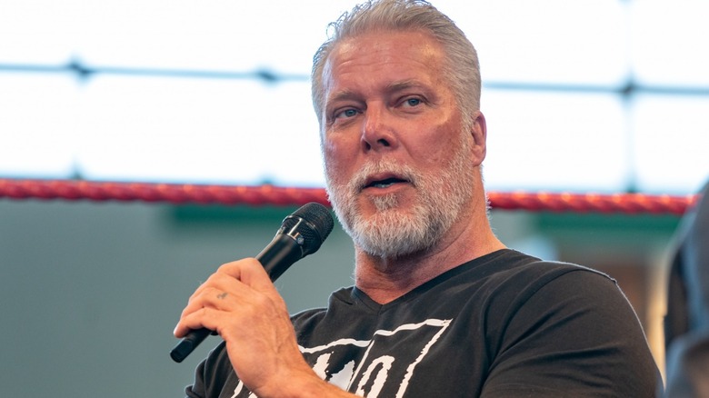 Kevin Nash holding a microphone