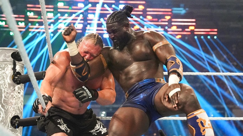"The Ruler" Oba Femi connects a nasty elbow on "The Beast" Brock Lesnar in the corner