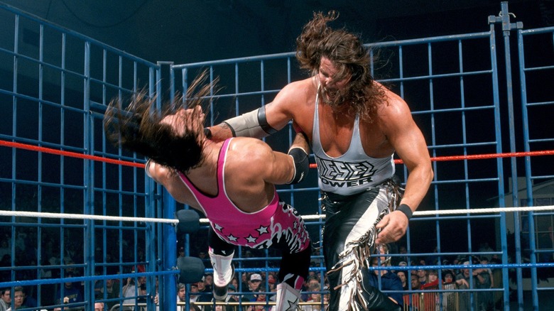 Bret Hart being hit with a massive Clothesline from Kevin Nash (as Diesel) during their Steel Cage match in WWE.