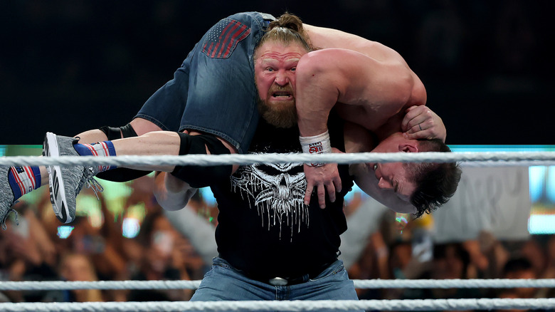 Brock Lesnar hoists John Cena up on his shoulders before hitting an F-5
