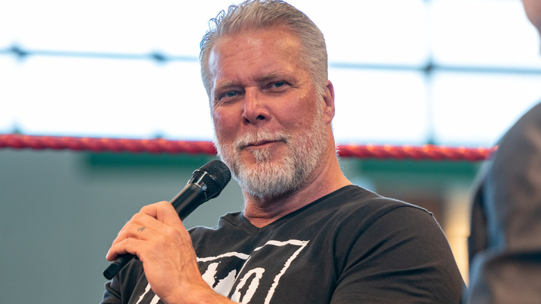 Kevin Nash holding a microphone