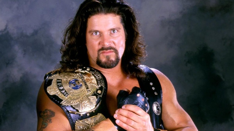 Kevin nash posing with the WWE World Championship during his reign in the 90s.