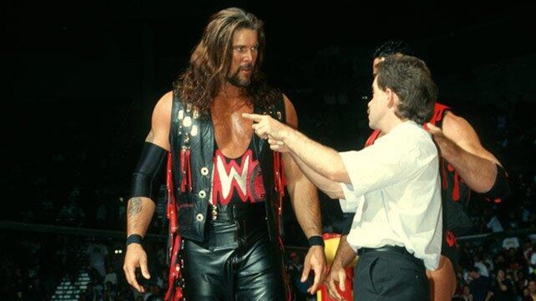 Kevin Nash and Scott Hall communicating with an official ahead of a match on WCW.