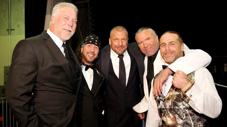 Kevin Nash, Sean Waltman, Paul Levesque, Scott Hall, and Shawn Michaels all posing together backstage.
