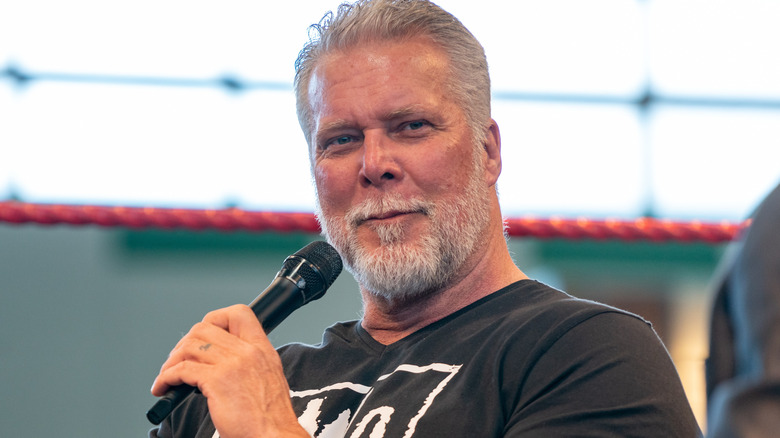 Kevin Nash holding a microphone