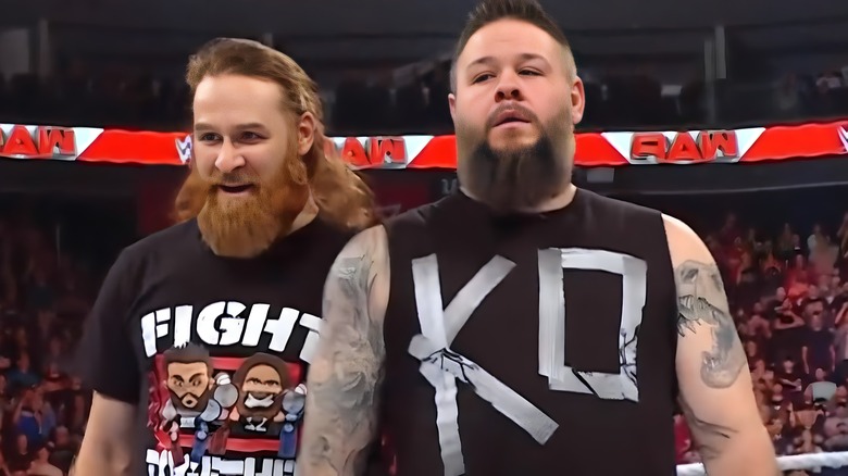 Sami Zayn and Kevin Owens stand in the ring