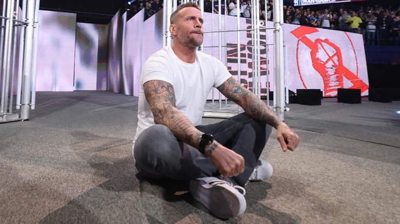 CM Punk Sits On The Stage After His WWE Return