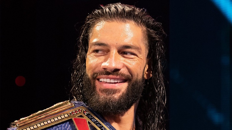 Roman Reigns smiling with title