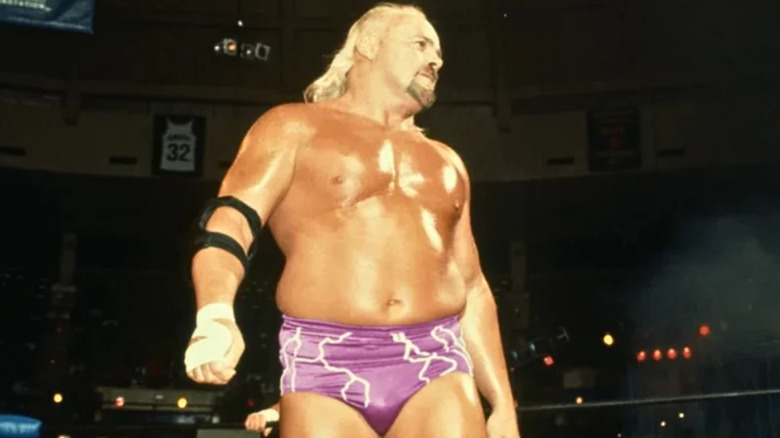 Kevin Sullivan wearing purple wrestling trunks