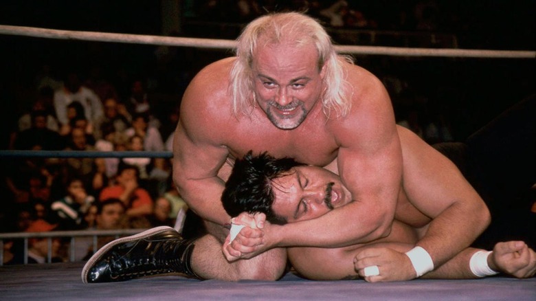 Kevin Sullivan applies a headlock during a WCW match