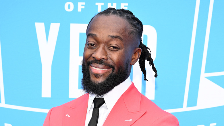 Kofi in front of a blue and white background