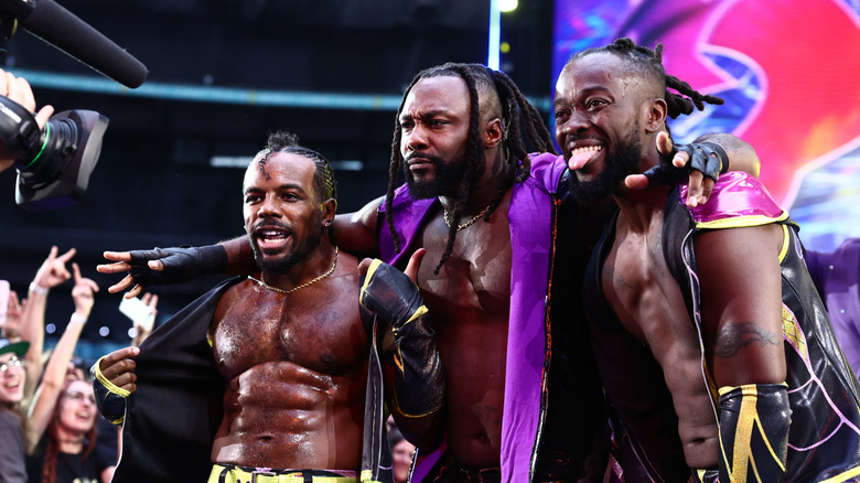Austin Creed, Swerve Strickland, and Kofi pose together on the stage following New Level's AEW debut at All In: London 2026.