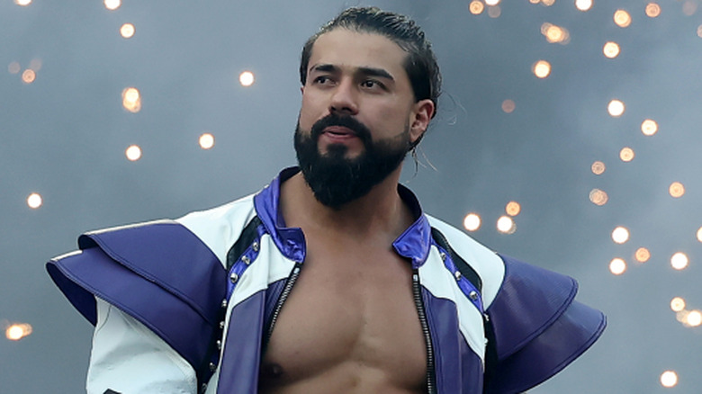 Andrade is wearing a black and white ring jacket