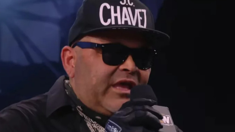 Konnan speaking into microphone