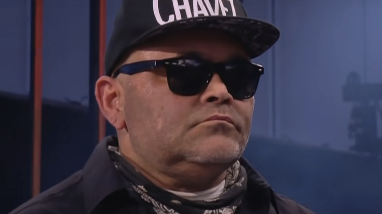 Konnan listening to headset