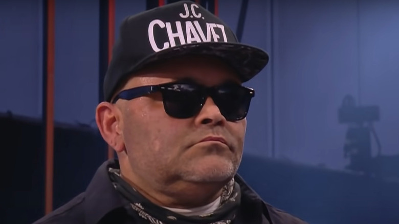 Konnan wearing sunglasses and cap