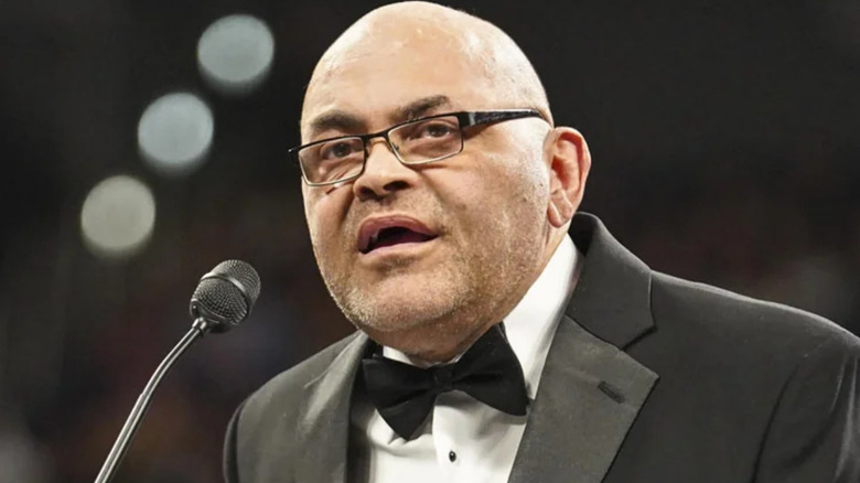 Konnan wearing a black suit