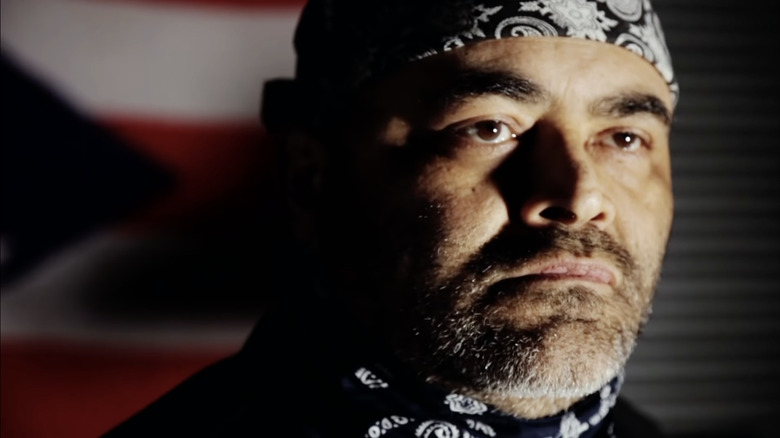 Konnan is serious while wearing a bandana