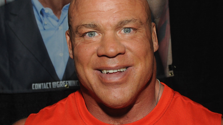 Kurt Angle smiles in a red shirt