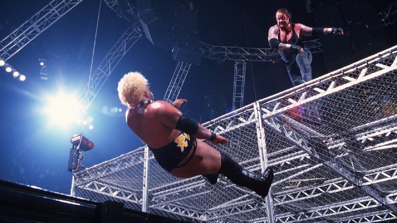 The Undertaker tosses Rikishi off the Cell