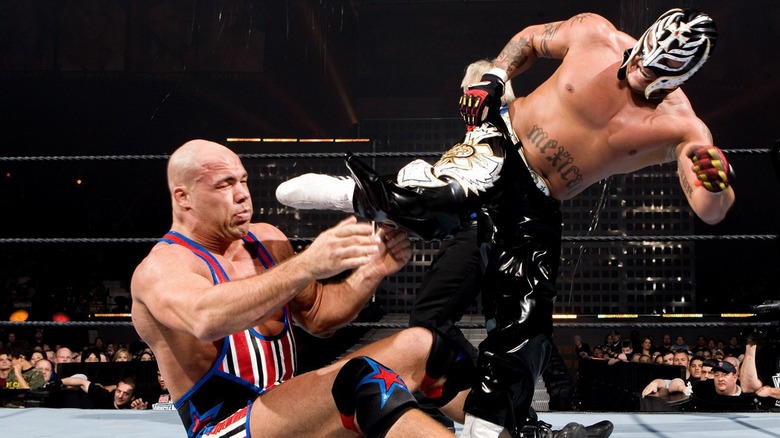 Rey Mysterio kicking Kurt Angle in face