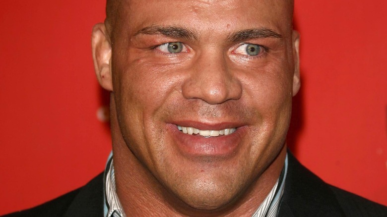 Kurt Angle smiling in a suit
