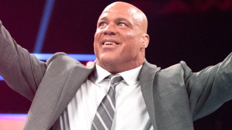 Kurt Angle wearing a suit and stretching his arms