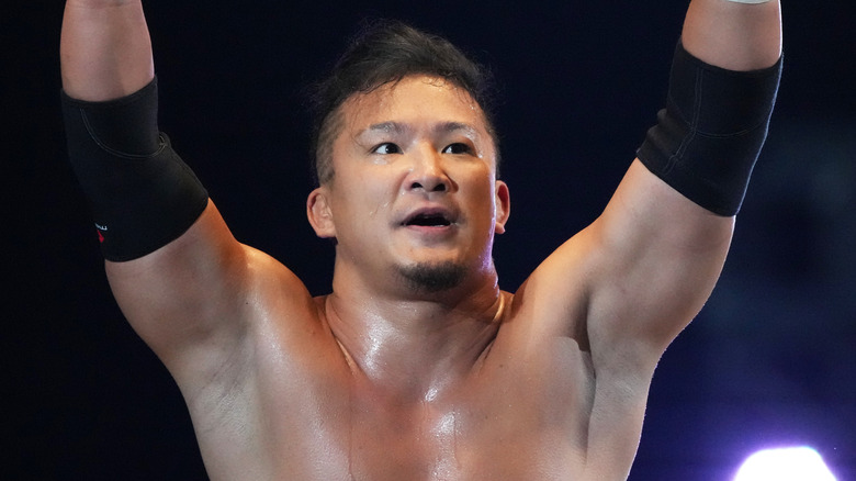 KUSHIDA with his arms raised