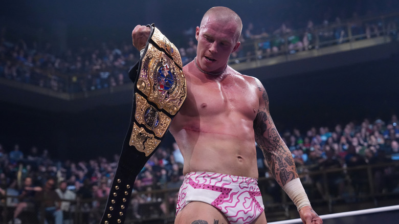 AEW International Champion Kyle Fletcher stares at the title following a victory on an episode of 
