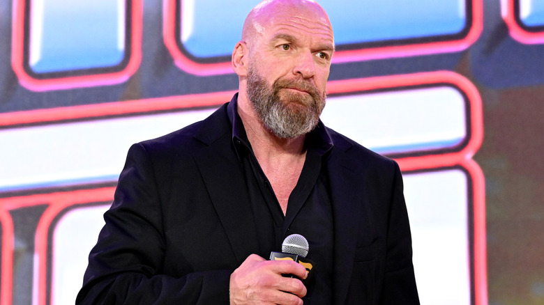 Paul Levesque with a microphone